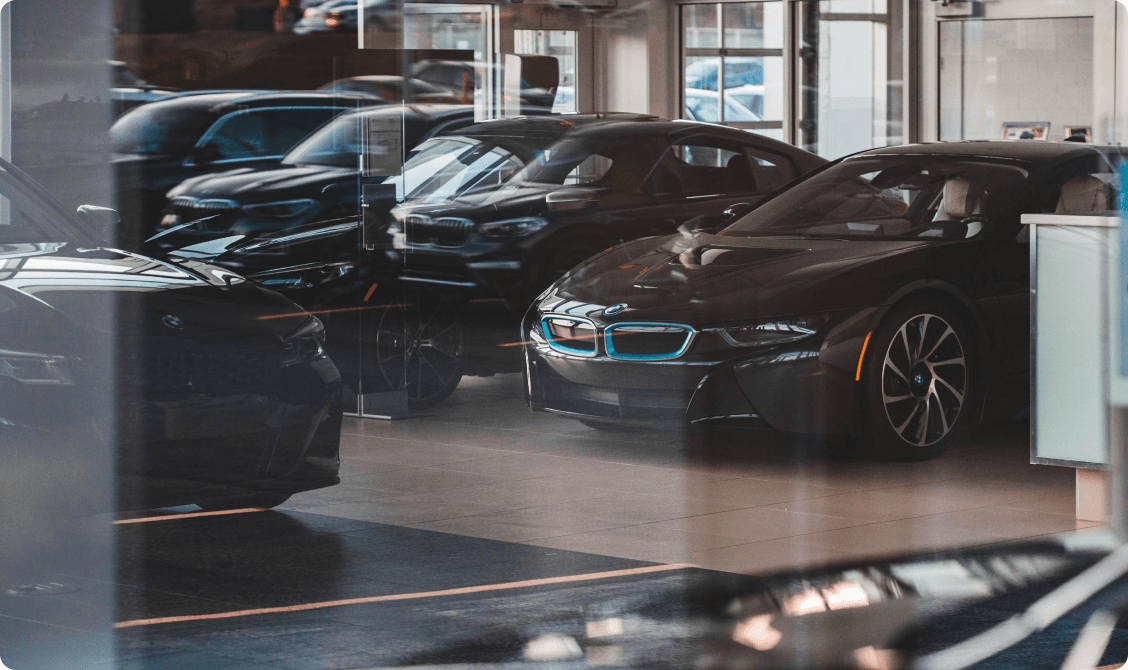 Used vehicles lined up on a dealership showroom floor